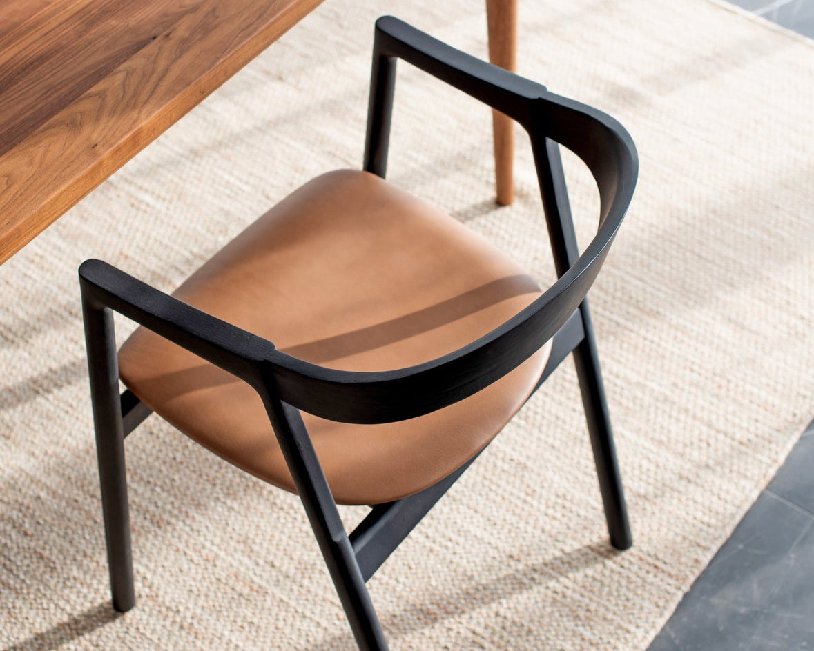 muna chair de gazzda en bois laqué noir assise en cuir avec une table fawn en noyer dans espace contemporain référencé par longitude marseille