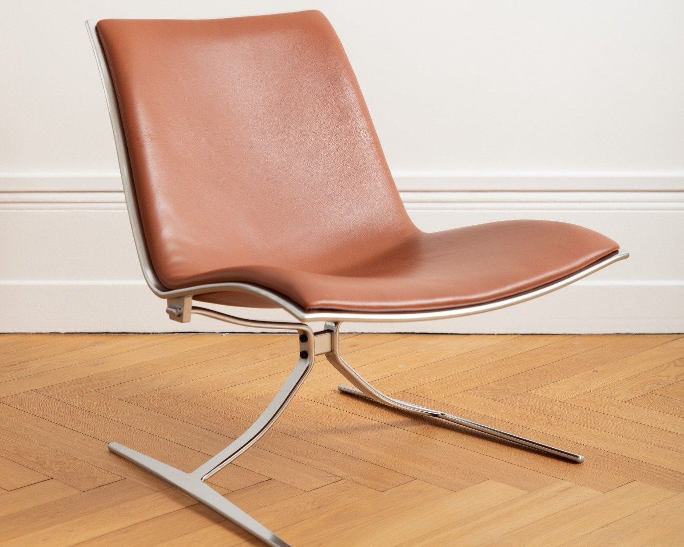 Fauteuil JK 710 Skater Chair en cuir cognac, design Jørgen Kastholm, édité par Lange Production, présenté au showroom Longitude Interior Design à Marseille, vue de trois quart droit