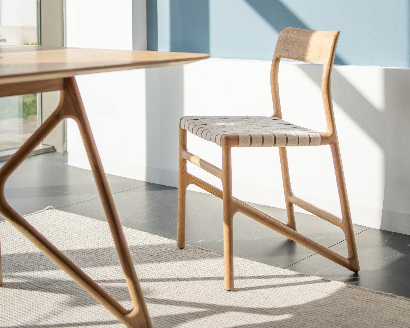 Chaise Fawn par Gazzda en chêne massif avec assise en sangle de coton blanc, présentée dans un intérieur lumineux