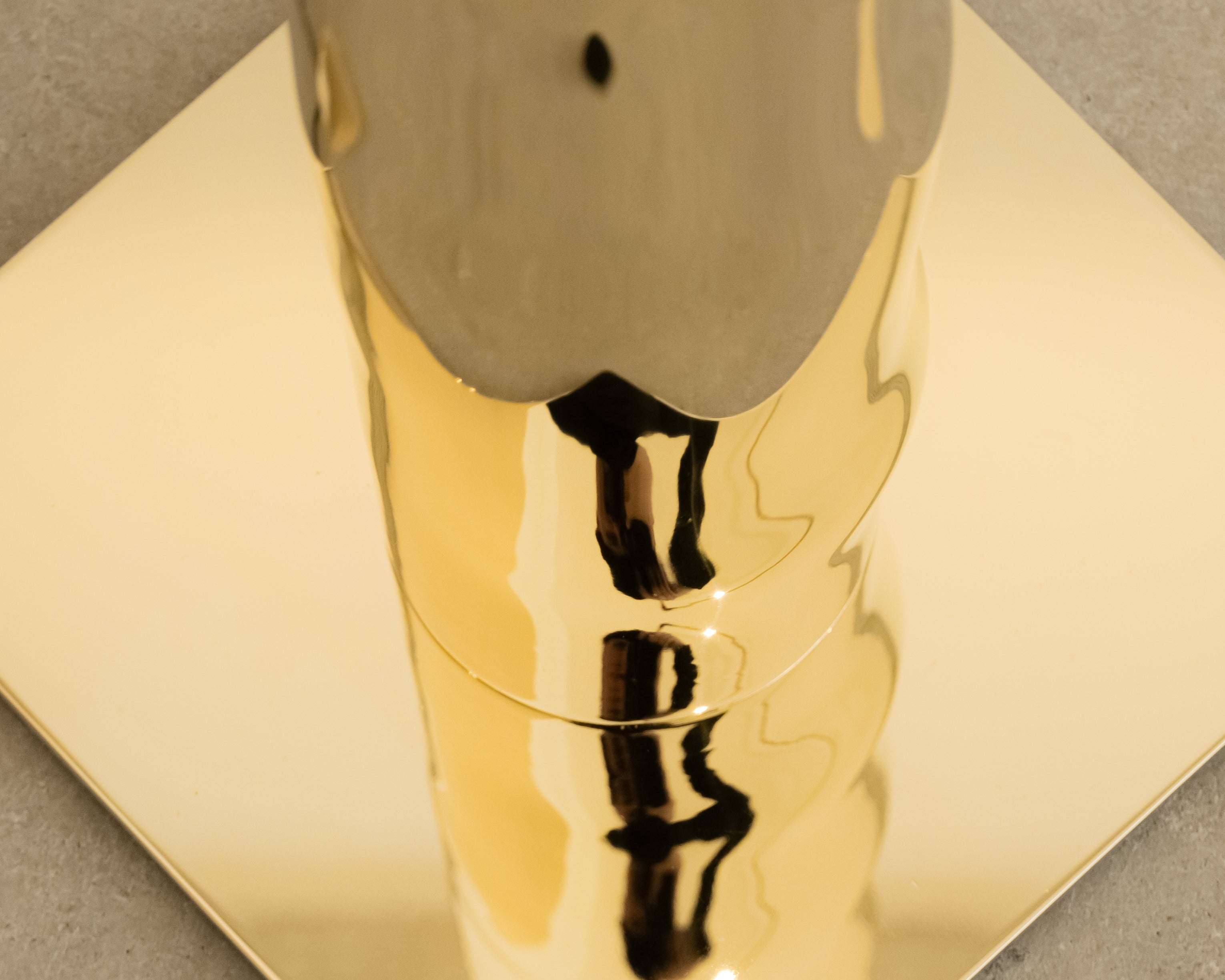 Détail du lampadaire helios façonné à la main en laiton par victor tison Reflet et jeu de lumiere sur le socle